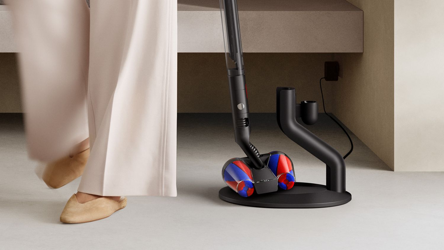 Dyson PencilVac Fluffycones — placing the vacuum on its charging dock