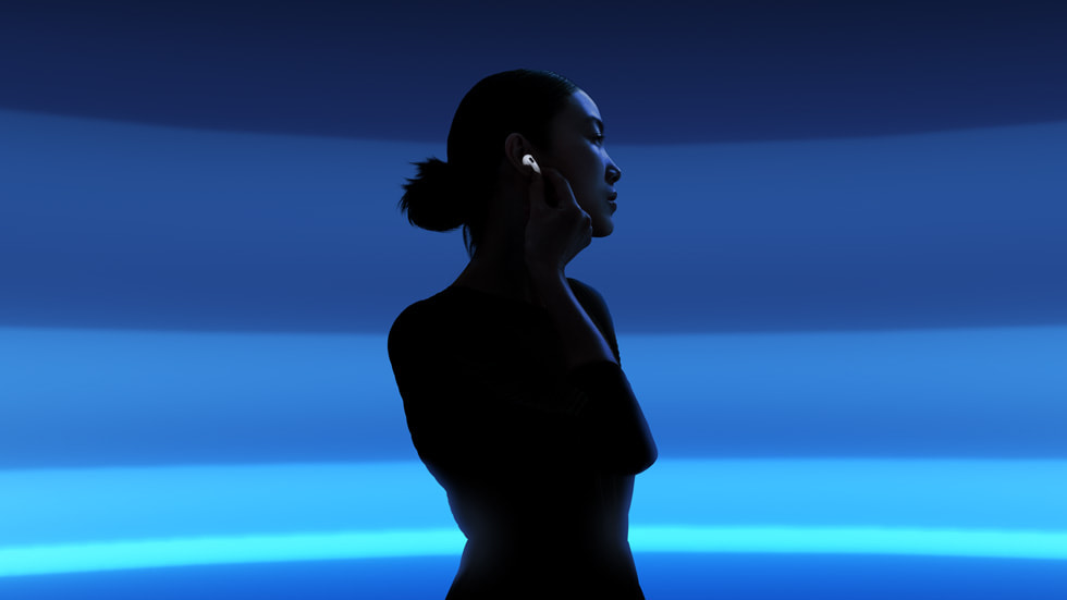 Person wearing Apple AirPods 4 with Active Noise Cancellation — official Apple lifestyle image