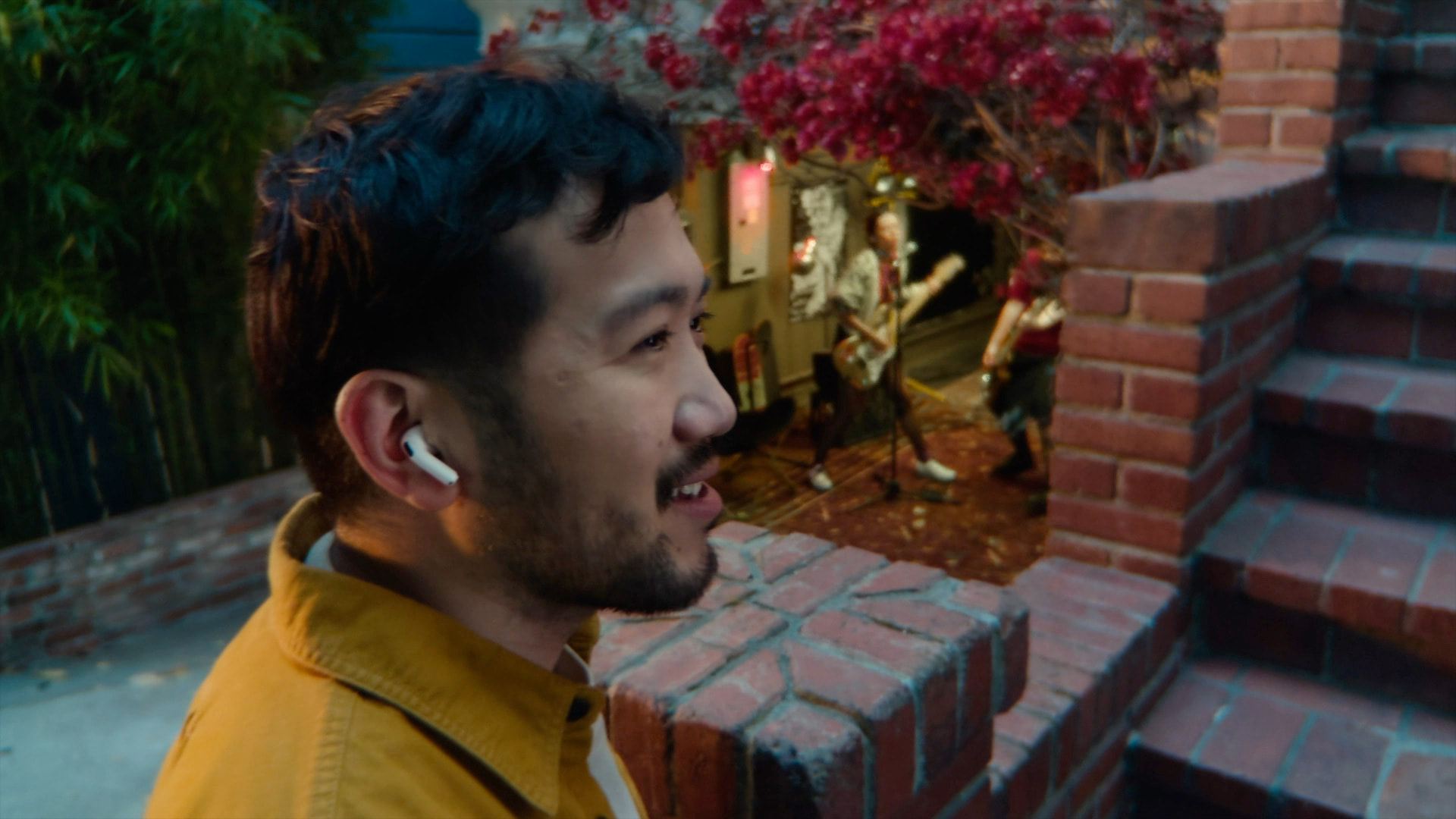 Person wearing Apple AirPods 4 during Voice Isolation demonstration — official Apple image