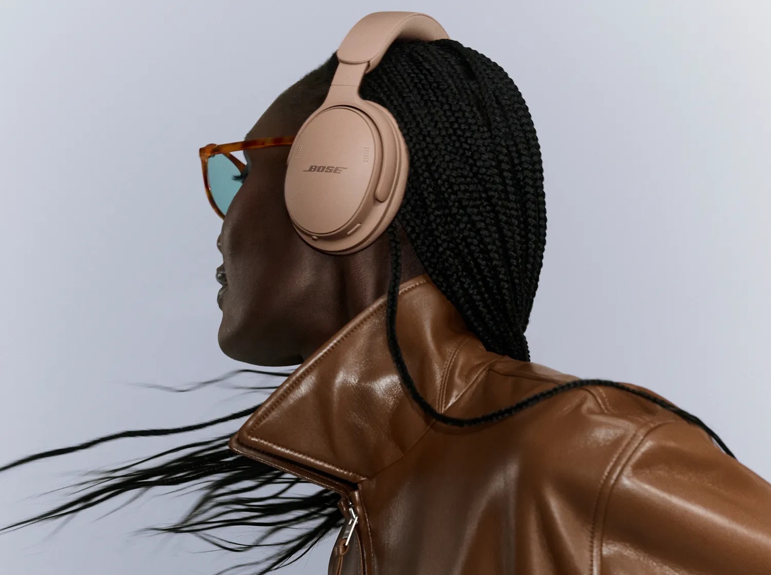 Bose QuietComfort Headphones (2nd Gen) in Hazelnut Taupe — side lifestyle view worn by a model