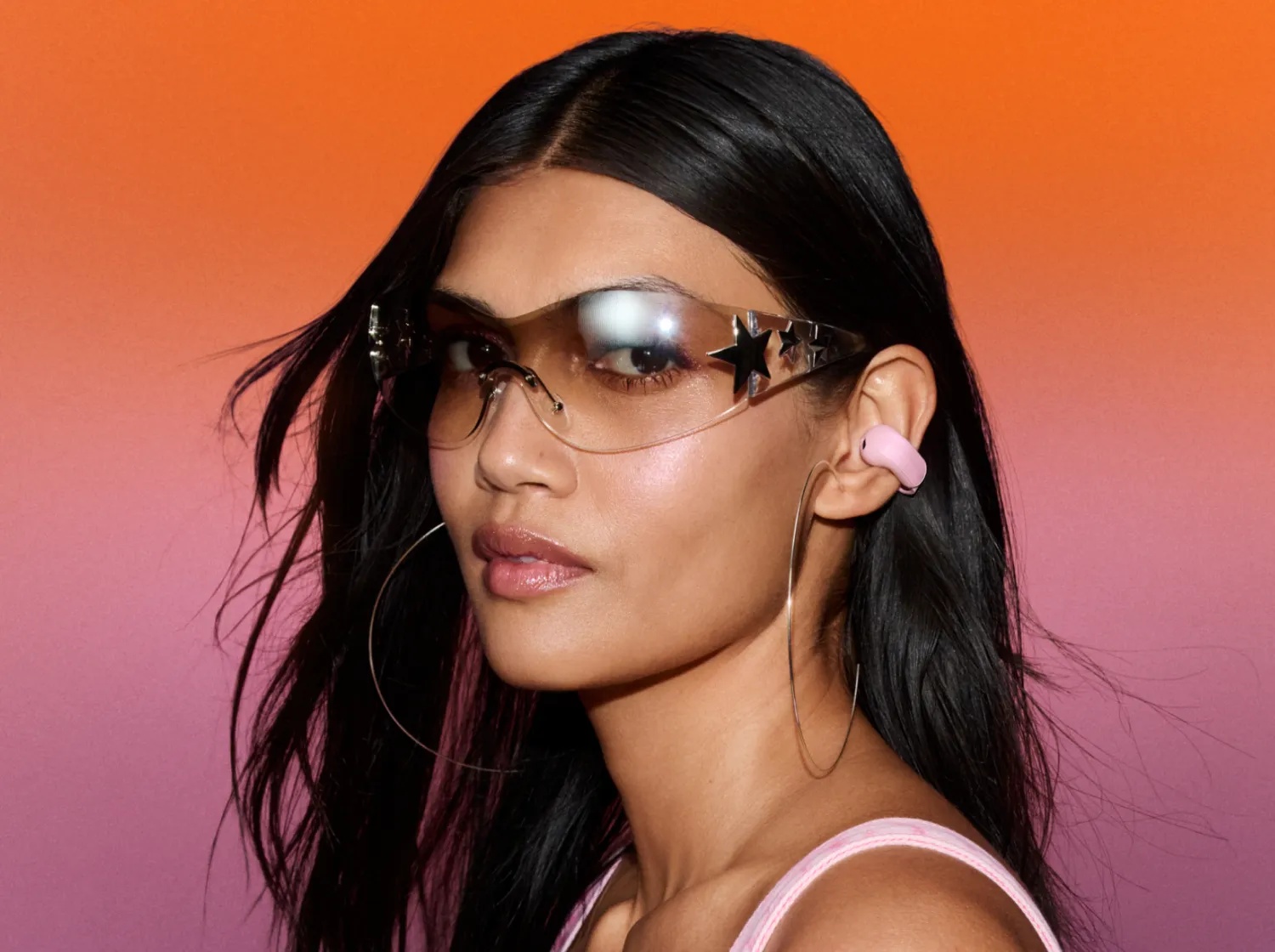 Bose Ultra Open Earbuds (2nd Gen) in Sky Pink — lifestyle view worn on the ear