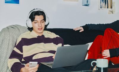 Sony ULT Wear Wireless Headphones (Off White) — Headphones worn while using a laptop and phone