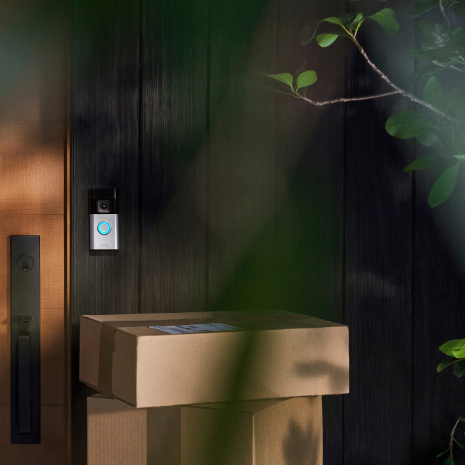 Ring Battery Video Doorbell Pro 2024 Satin Nickel — Doorbell installed beside a front door and packages